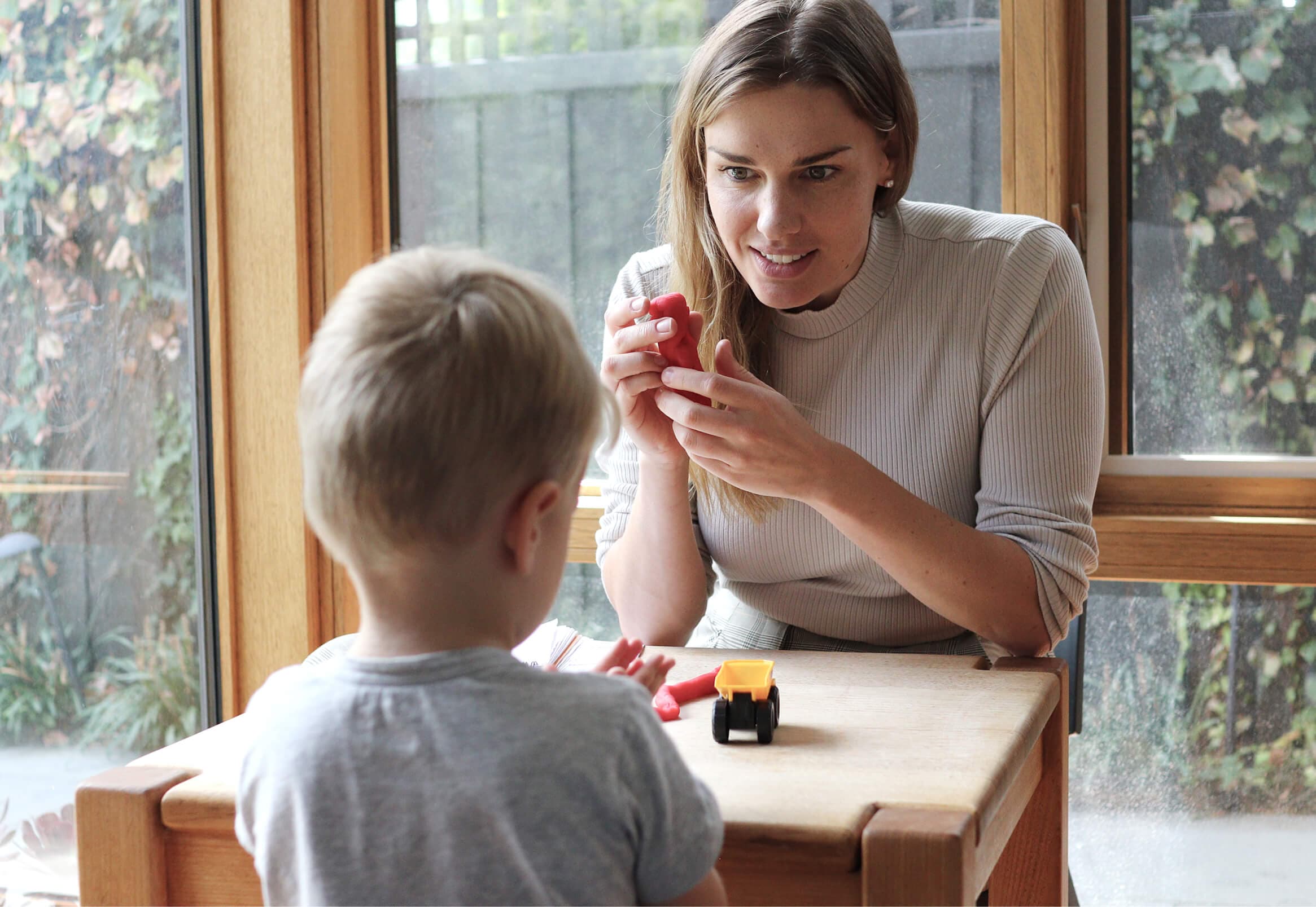 Olivia engaging with a child during a speech therapy session.